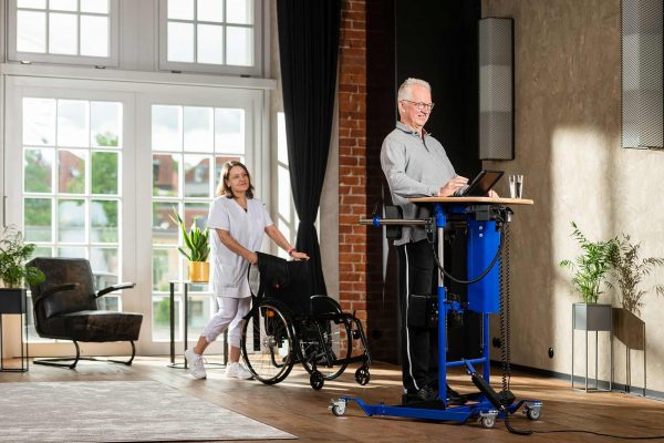 Patient in standing training on standing device